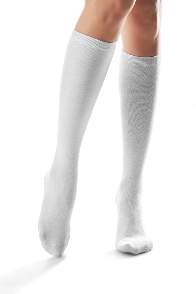 Person wearing white mid calf socks on a white background