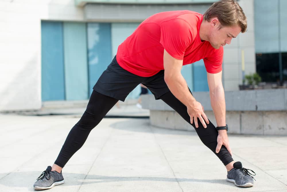 A close look at a man stretching before his work out routine.