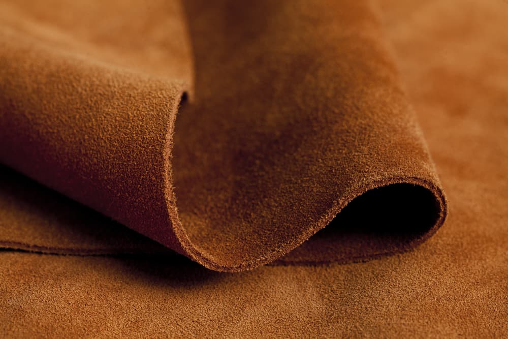 This is a close look at a piece of brown leather suede fabric.