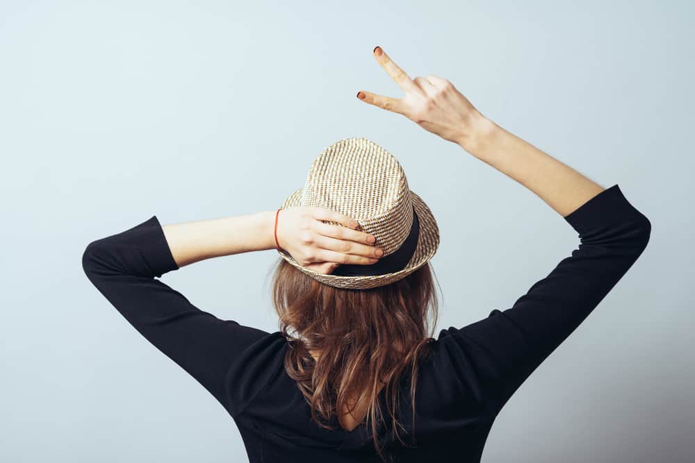 Back profile of a woman wearing brim kettle hat.