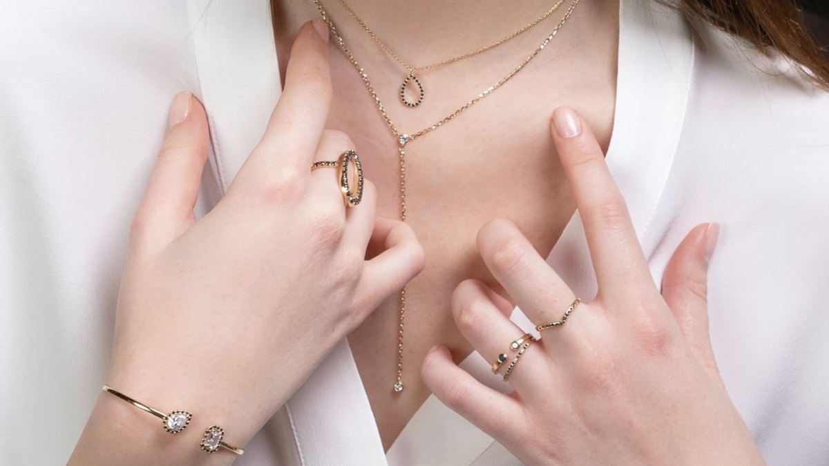 Close up of person wearing a lot of jewelry