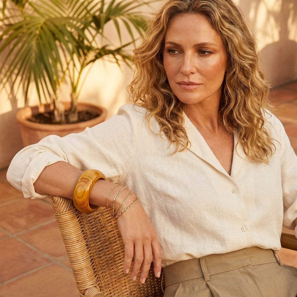 The Oversized Wood Bangle in a Natural Finish, Stacked With Gold Chains Like It Was the Law