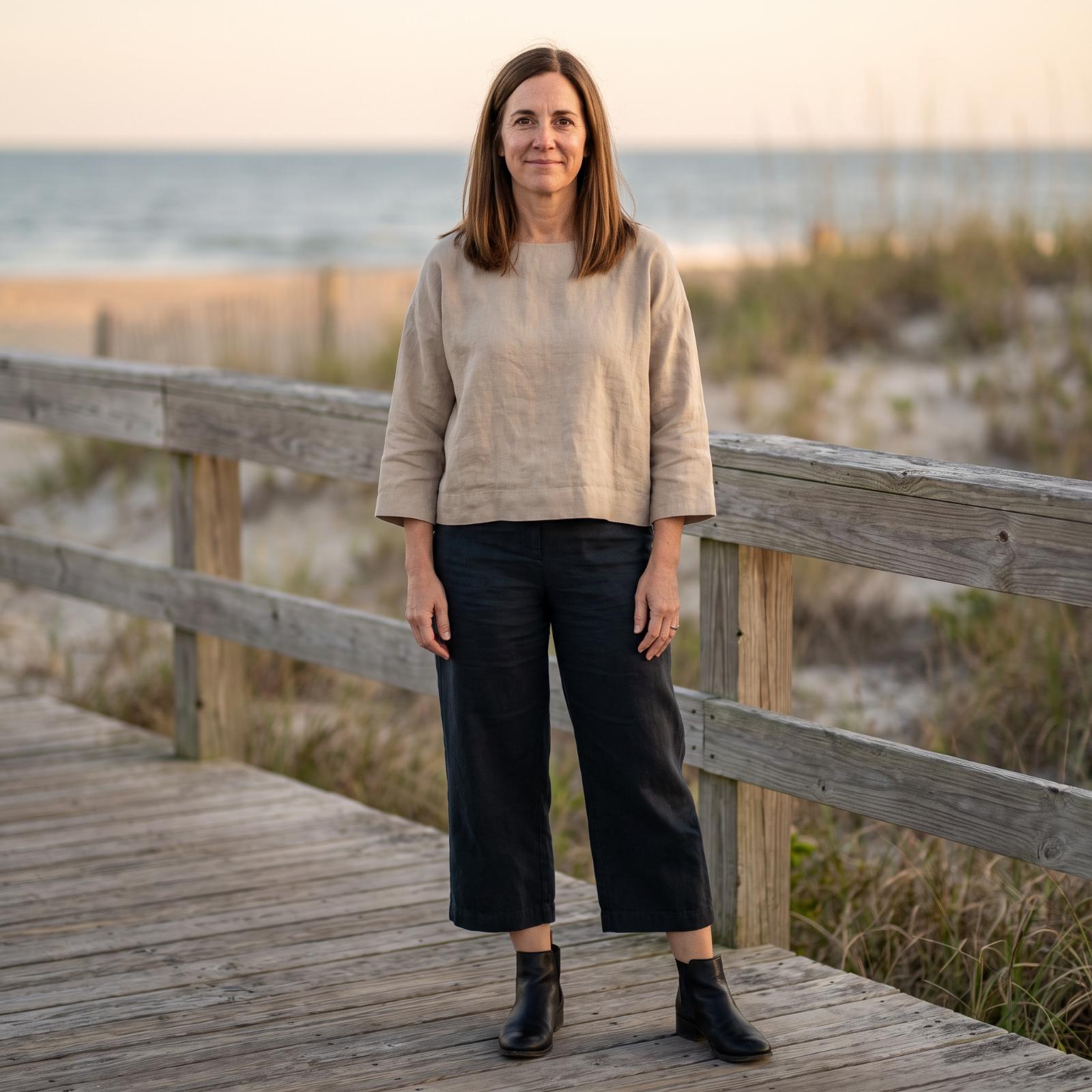 Woman over 45 wearing ankle boots with a fall outfit designed to keep the leg line long