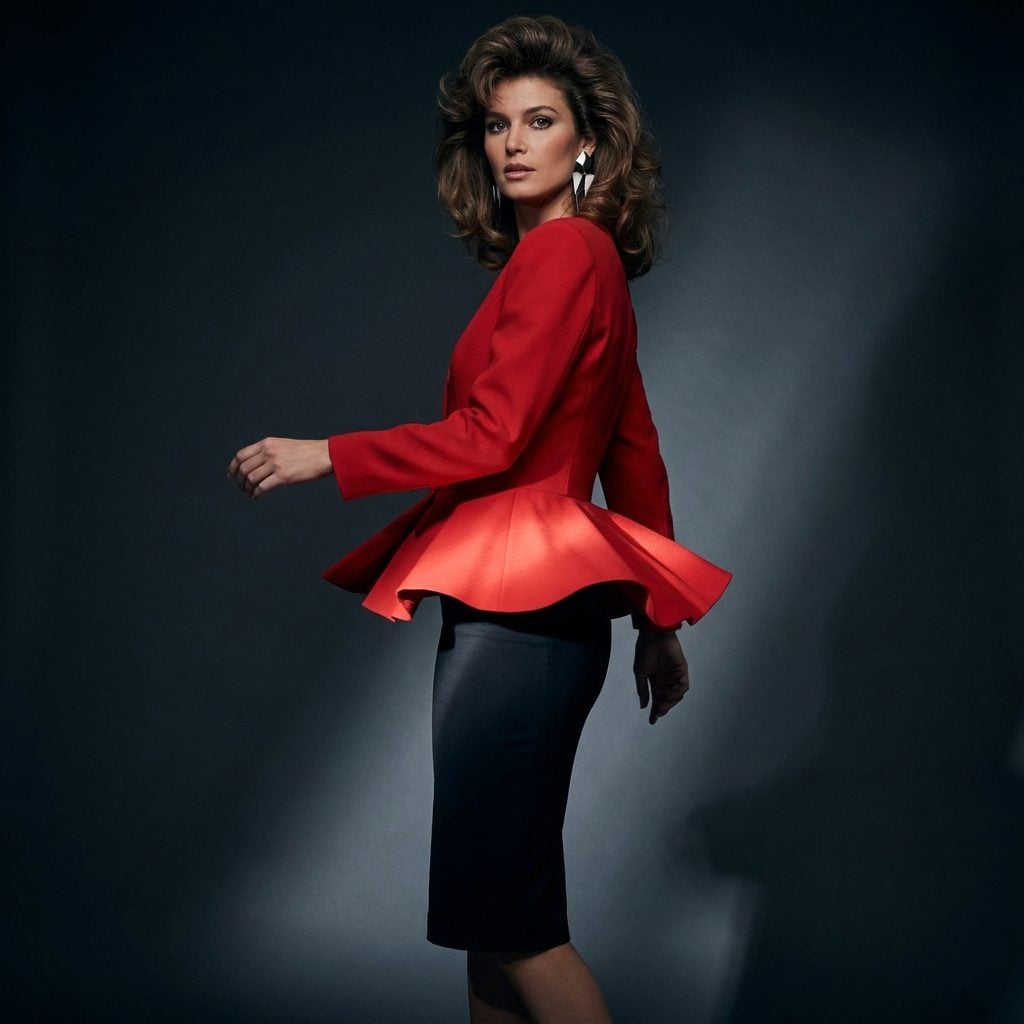 Red peplum jacket with strong shoulders and a narrow black skirt