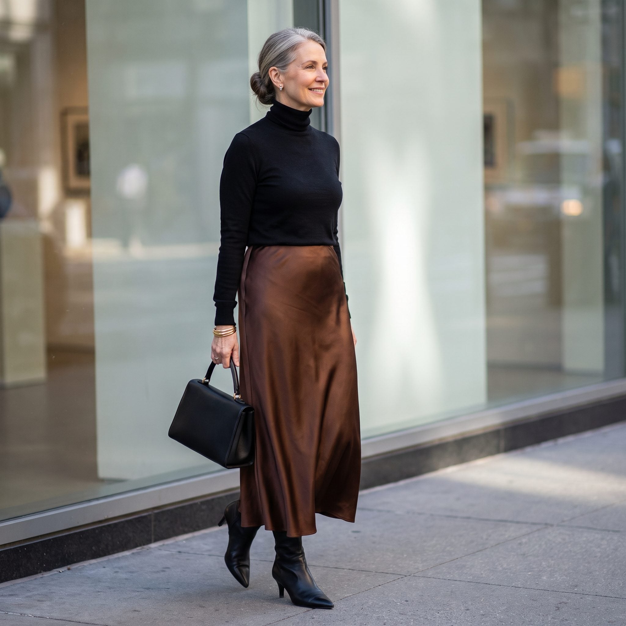 Bronze satin slip skirt with black turtleneck and pointed ankle boots