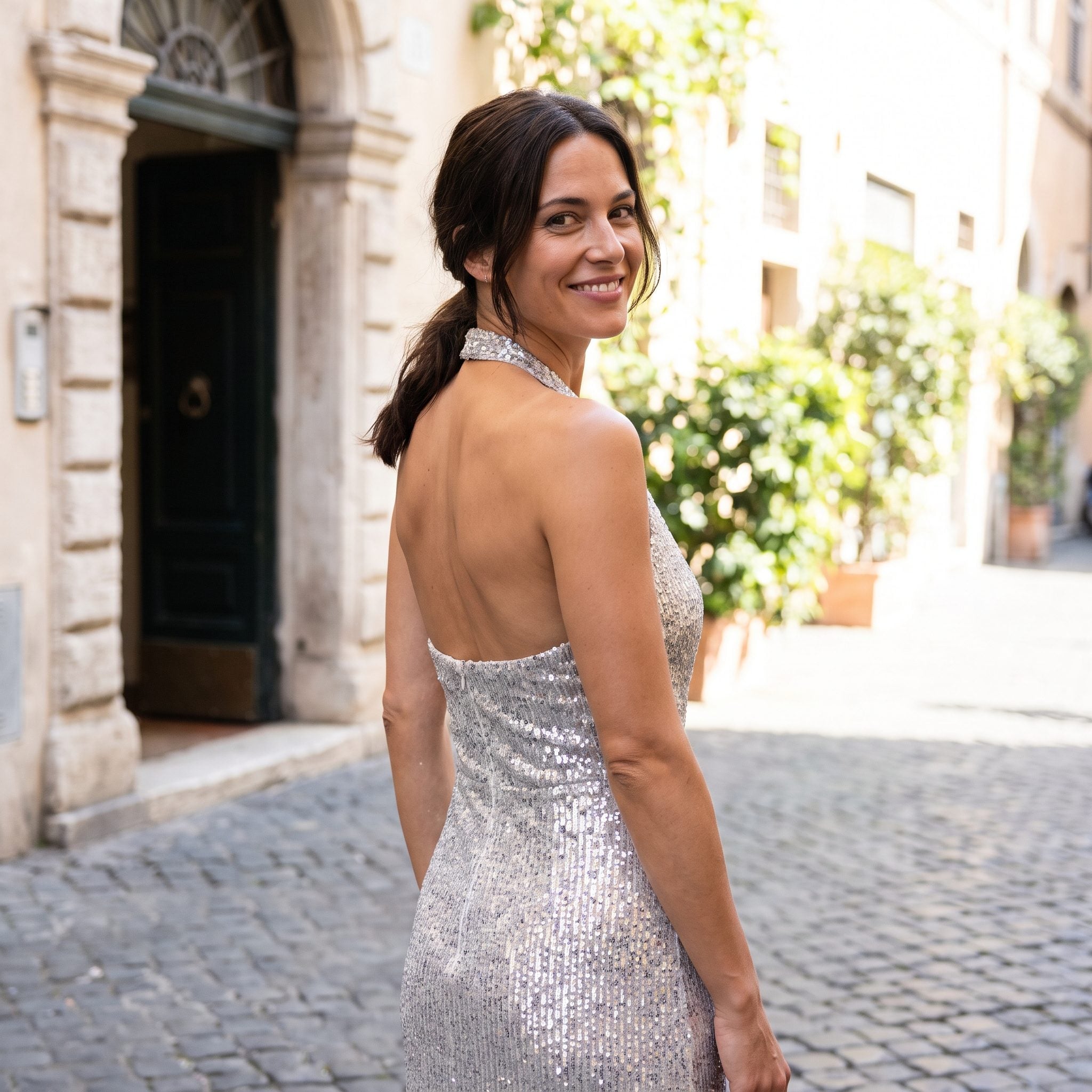 1970s emerald-green disco-inspired halter gown with an open back