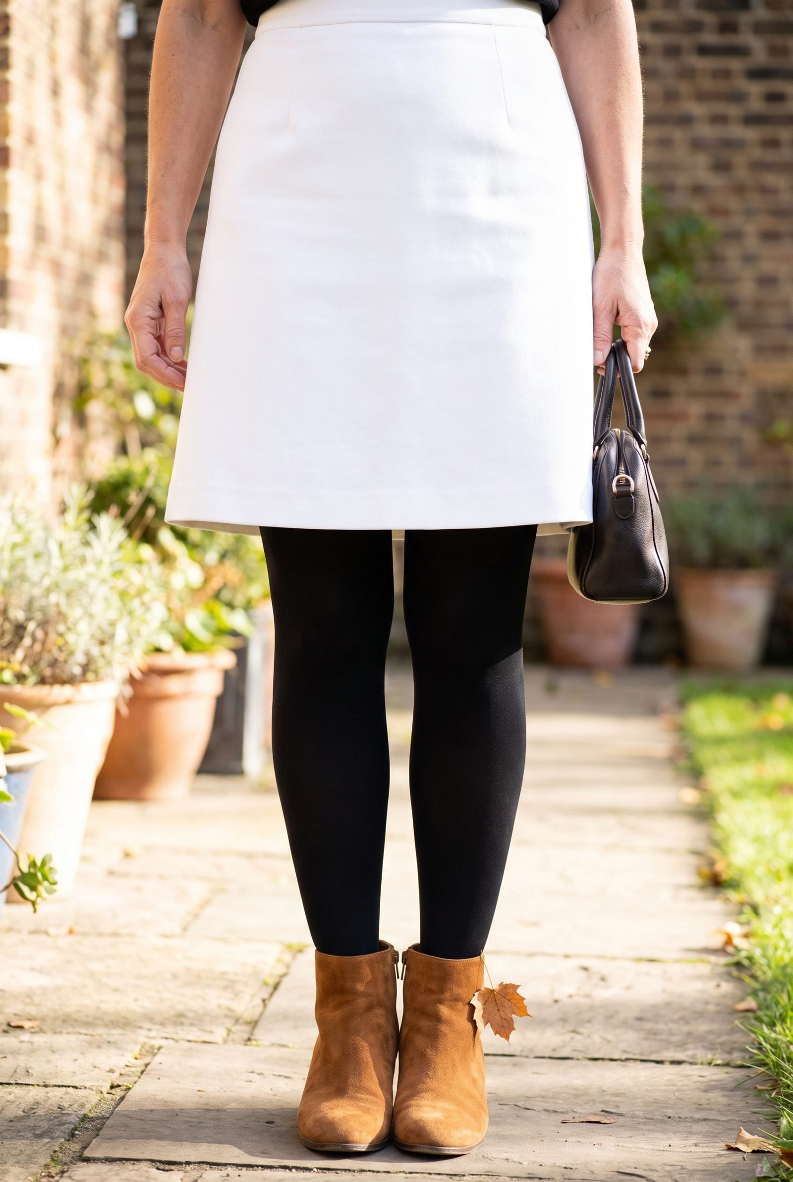 Black Tights With Caramel Suede Boots and a Stark White Skirt