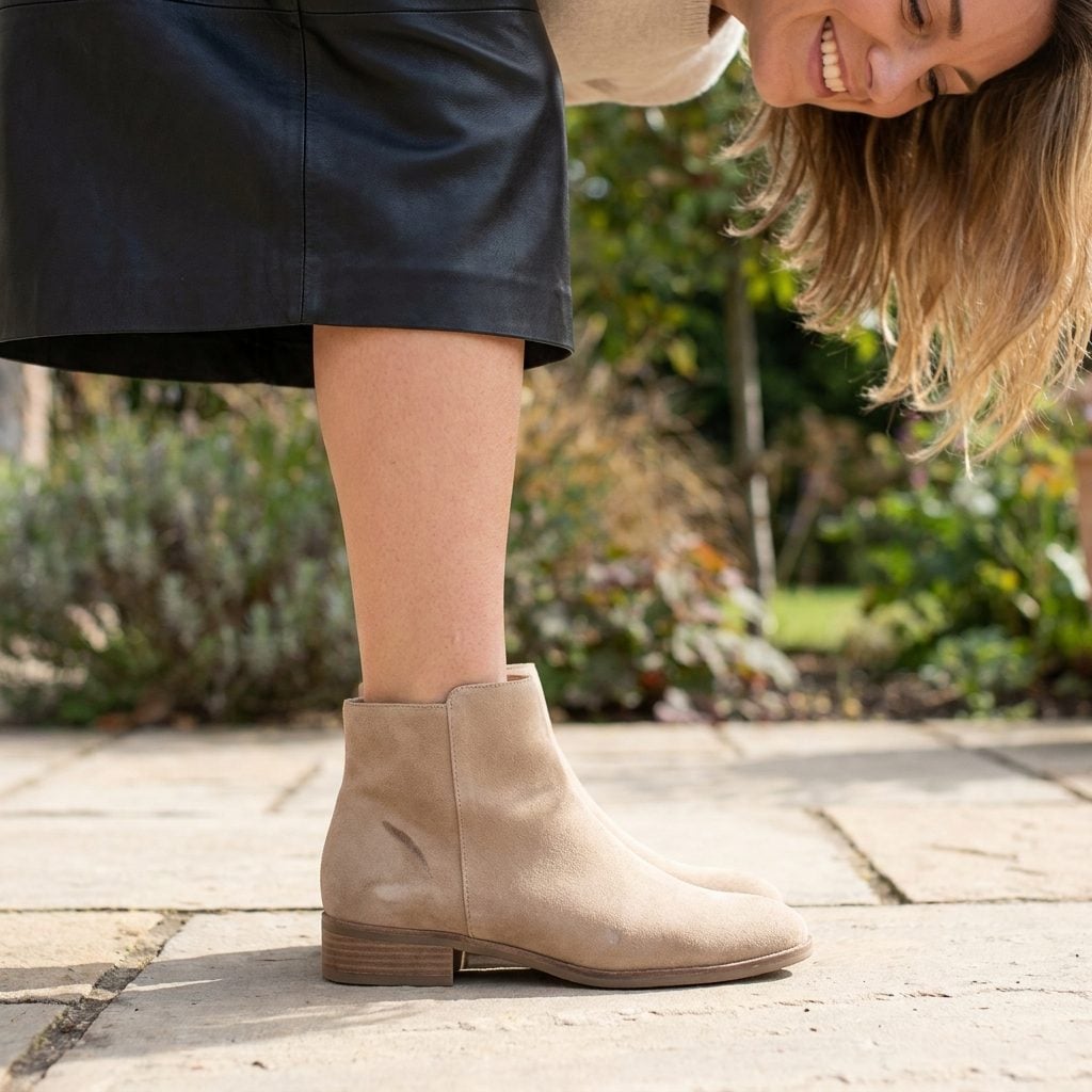 The Leather Skirt and Contrasting Beige Boot Building Three Fault Lines Across Your Legs
