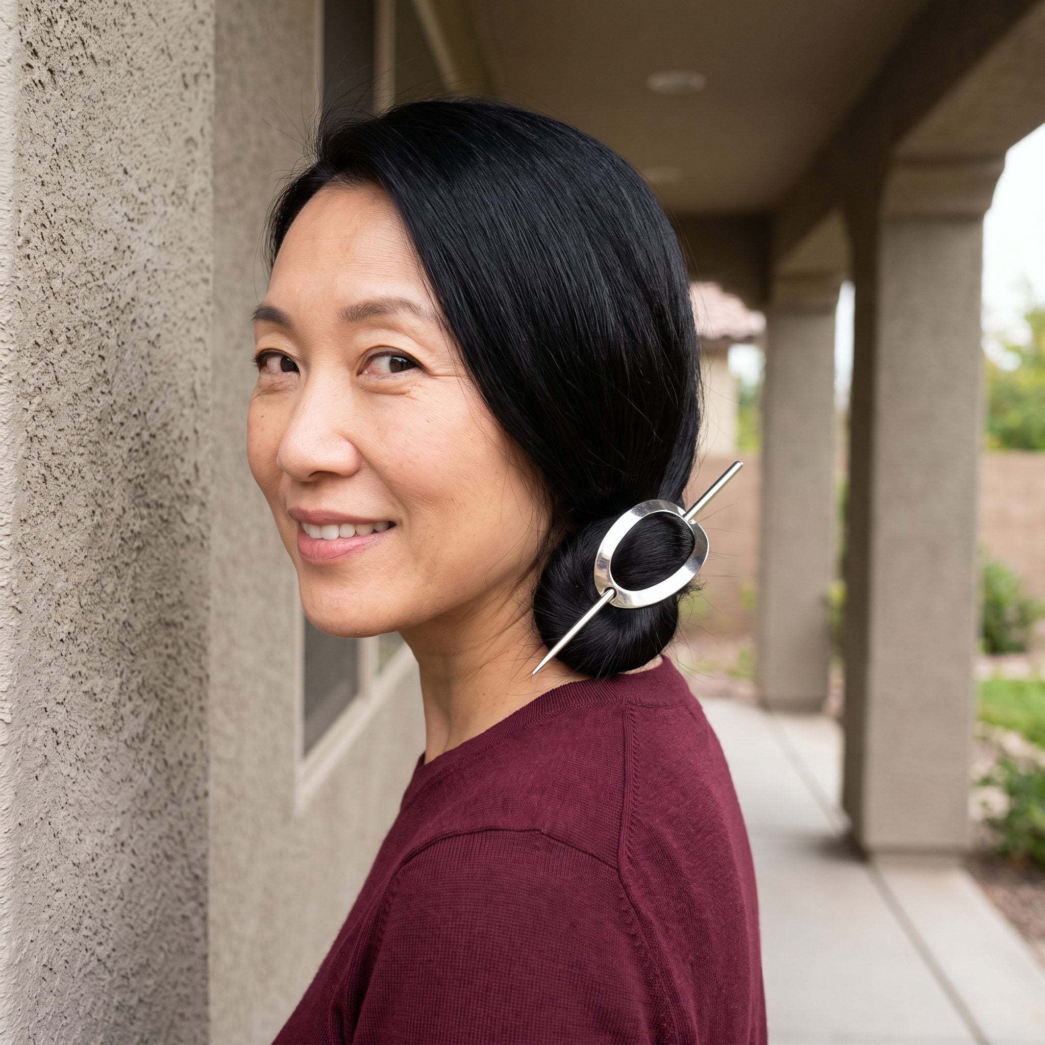The Metal Barrette With the Long Stick Through It