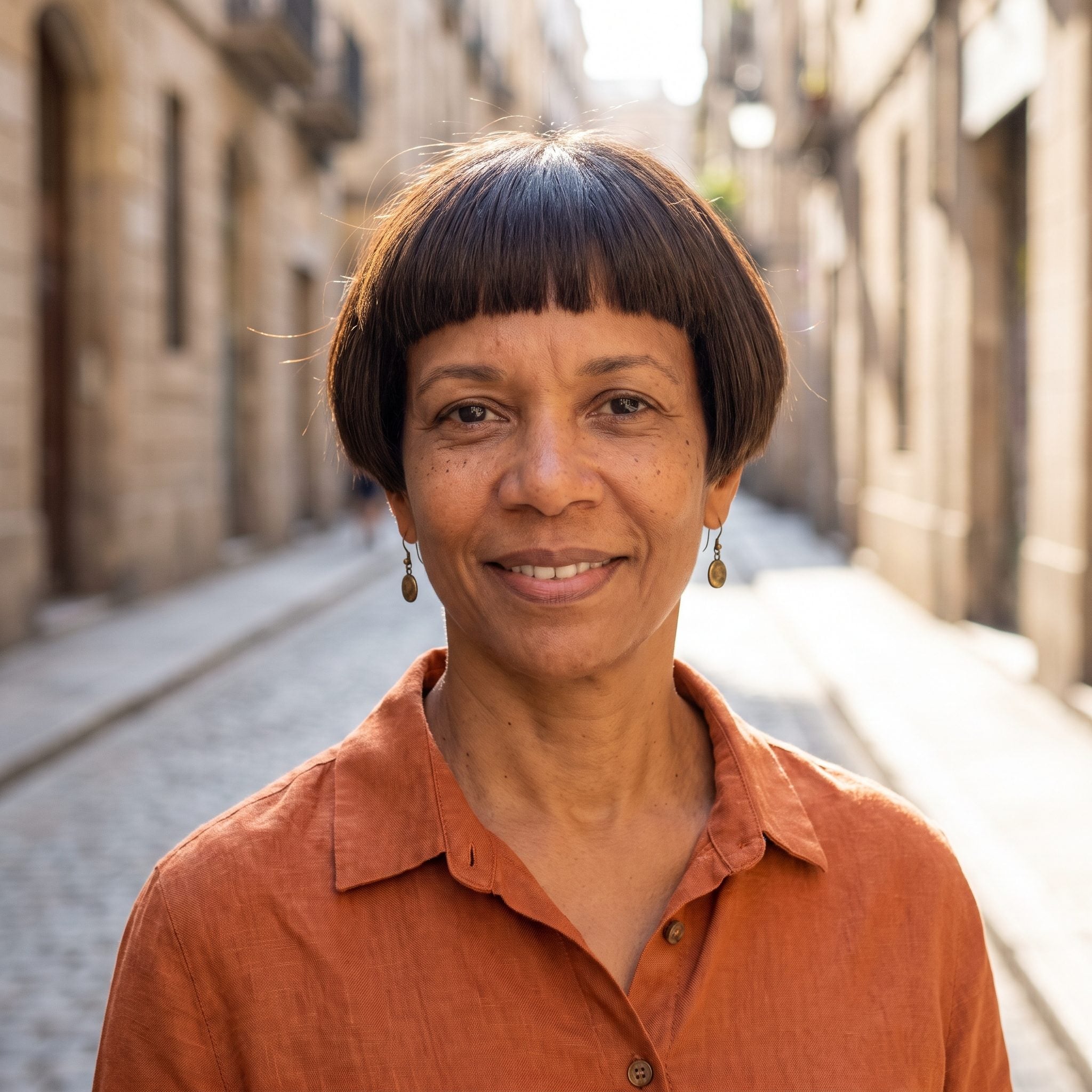 Woman with a dark brown pixie where the fringe and sides form one nearly uniform perimeter