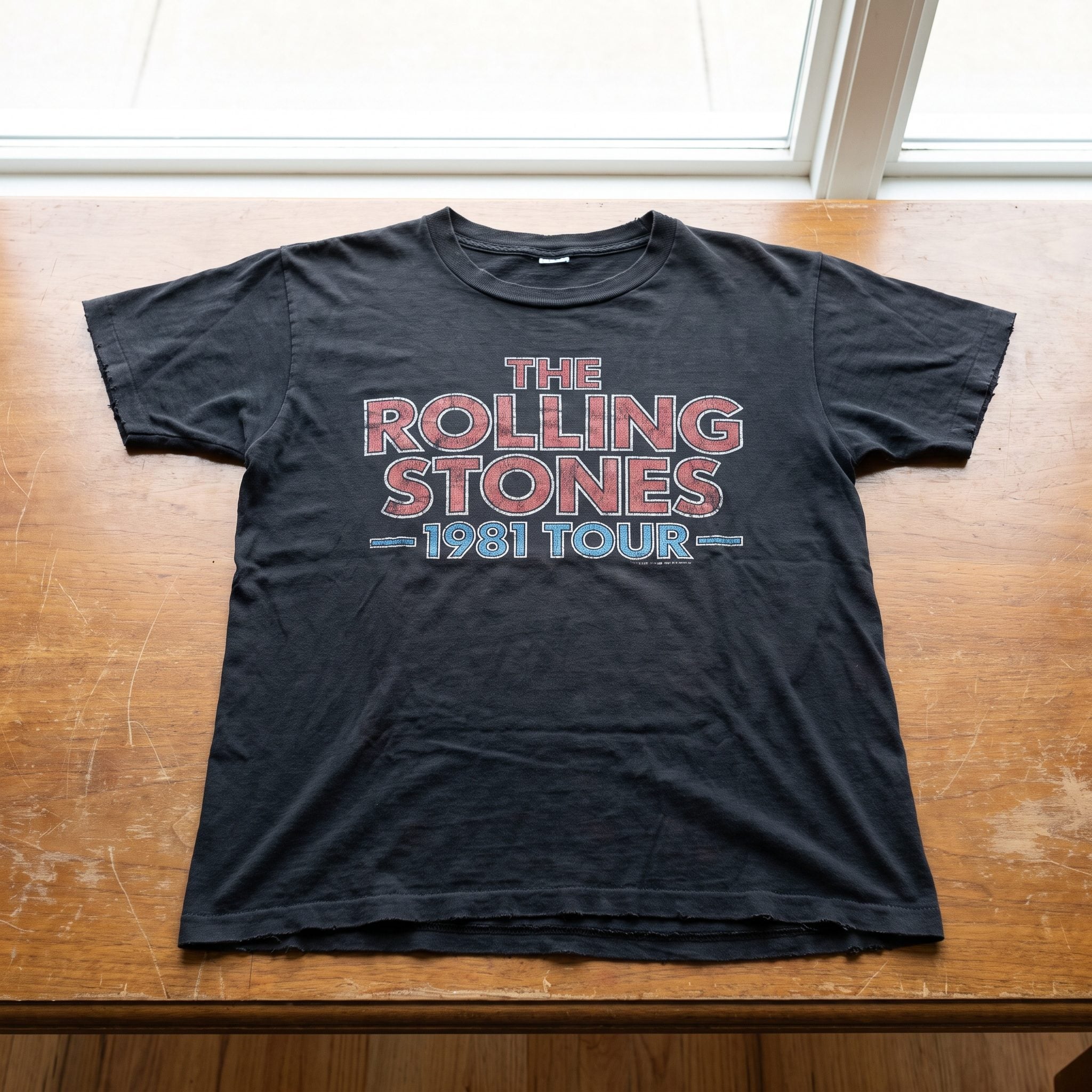 Faded graphic concert T-shirt styled with straight-leg jeans and white sneakers