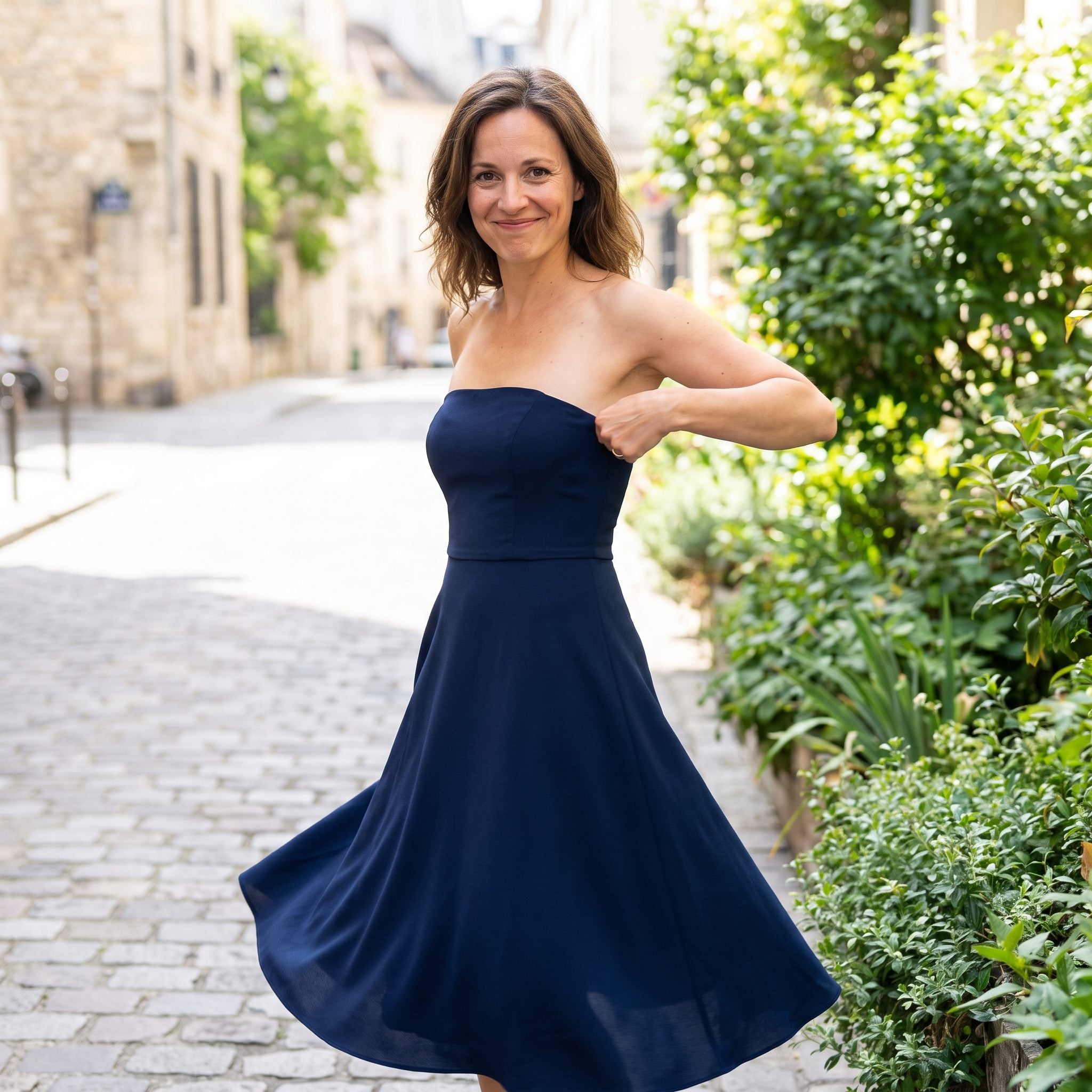 Navy strapless dress with a fitted bodice and flared crepe skirt