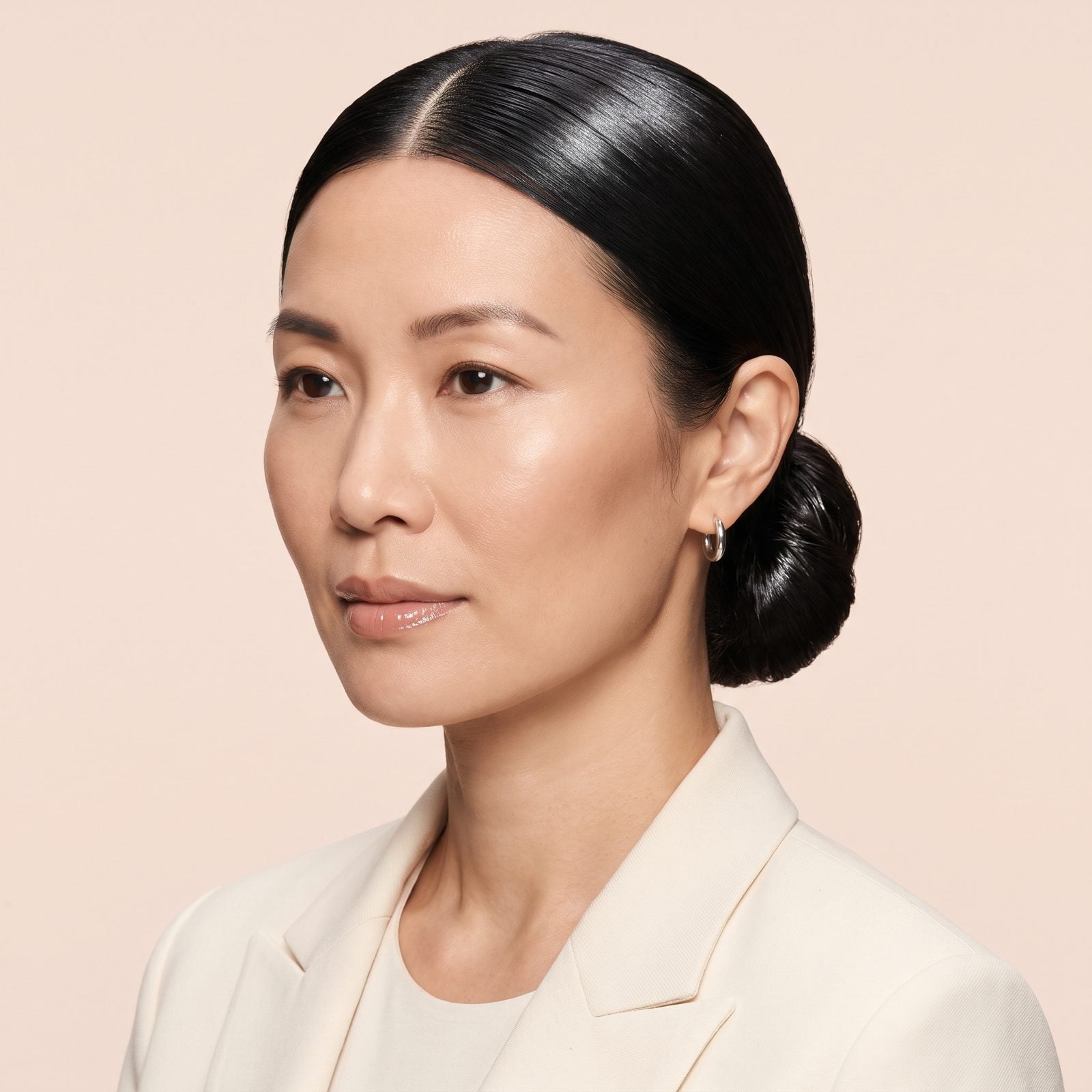 The 2020s Slicked Center-Part Bun With a Glass Finish