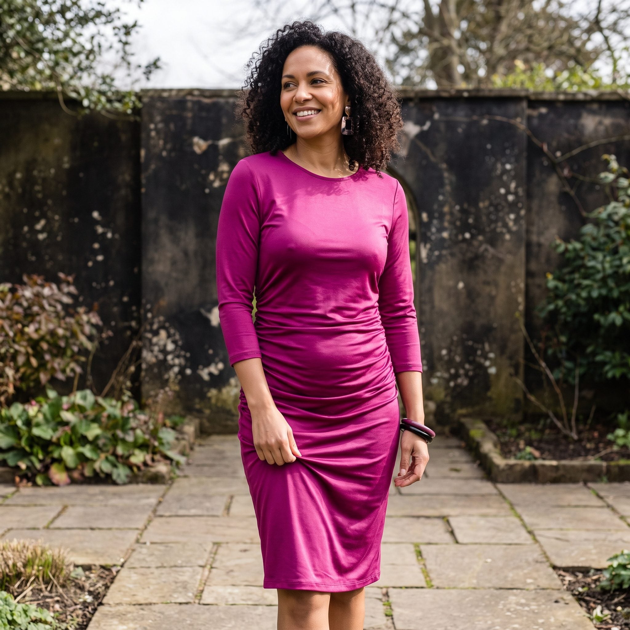 Magenta jersey evening dress with long sleeves and asymmetric ruching at the waist