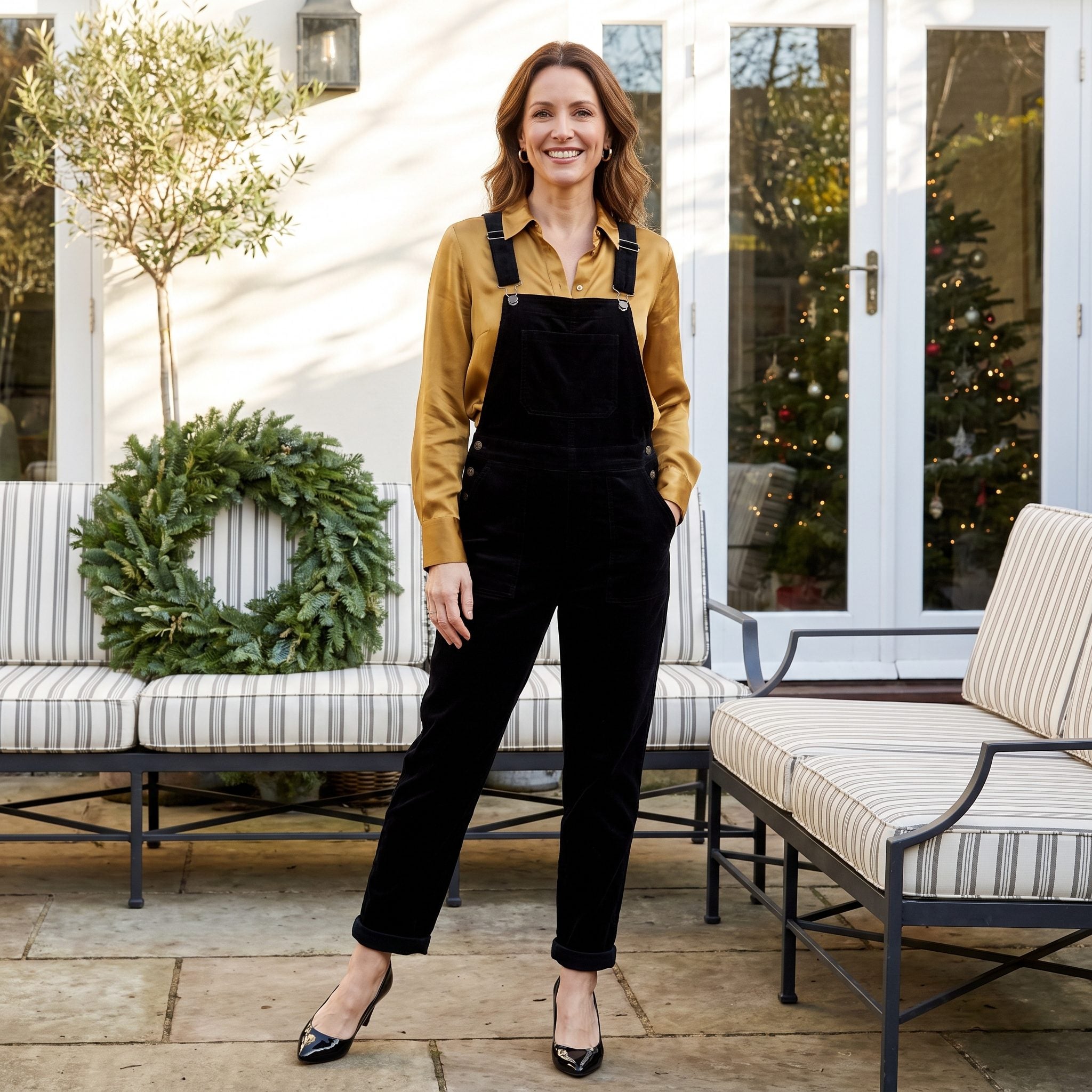 Black velvet dungarees over an antique-gold silk blouse with patent pumps