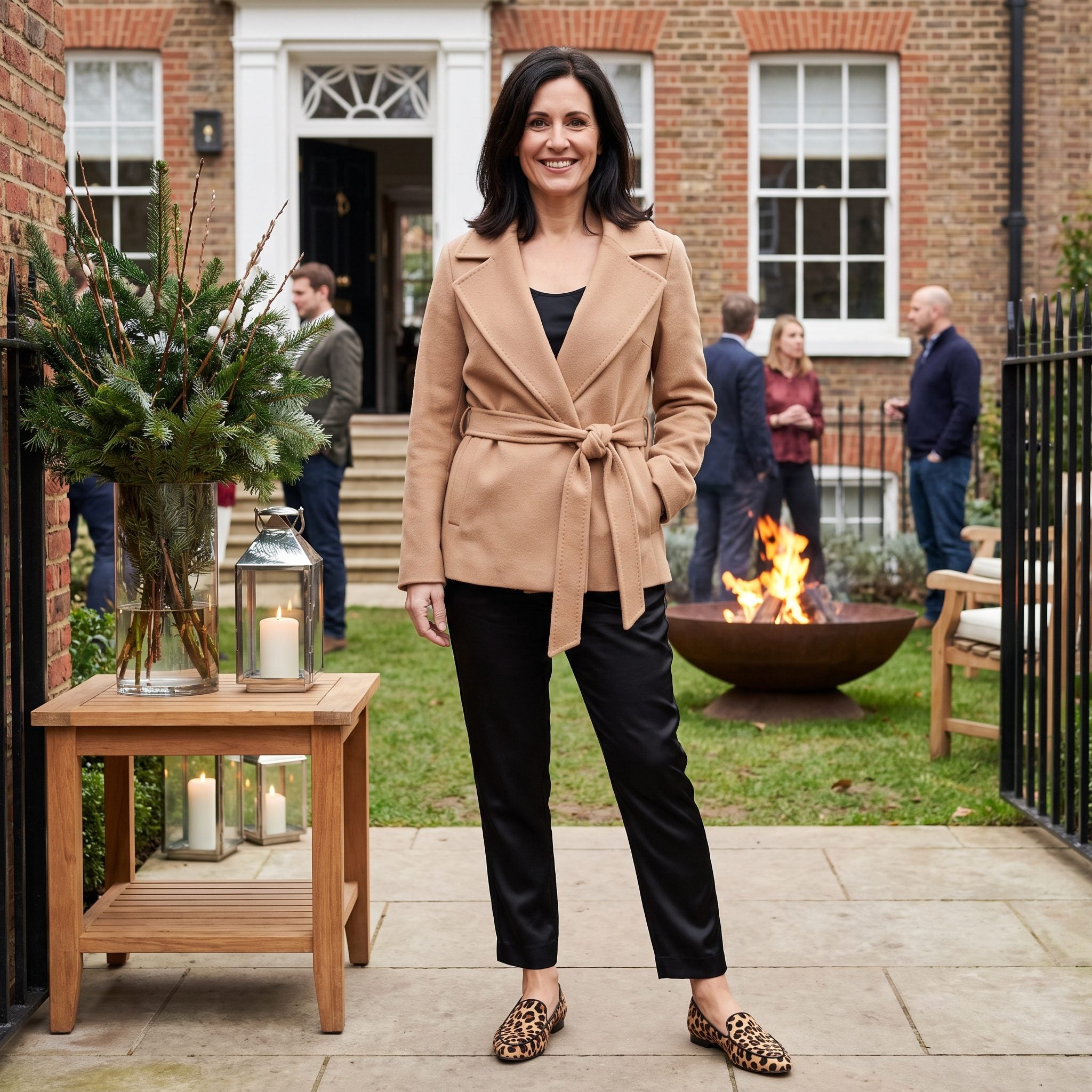 Camel wrap jacket with black satin trousers and leopard-print loafers