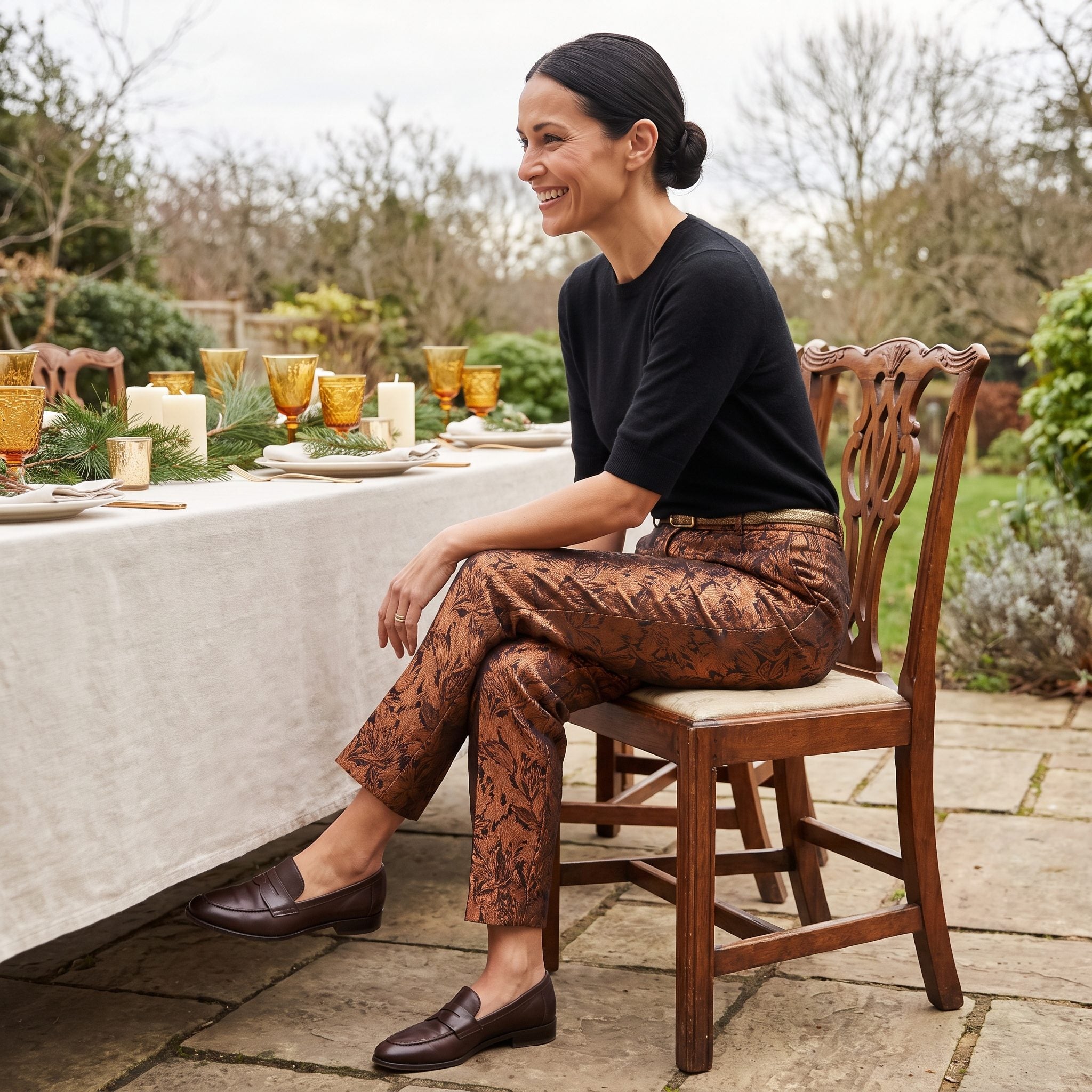 Copper jacquard trousers paired with a black cashmere sweater