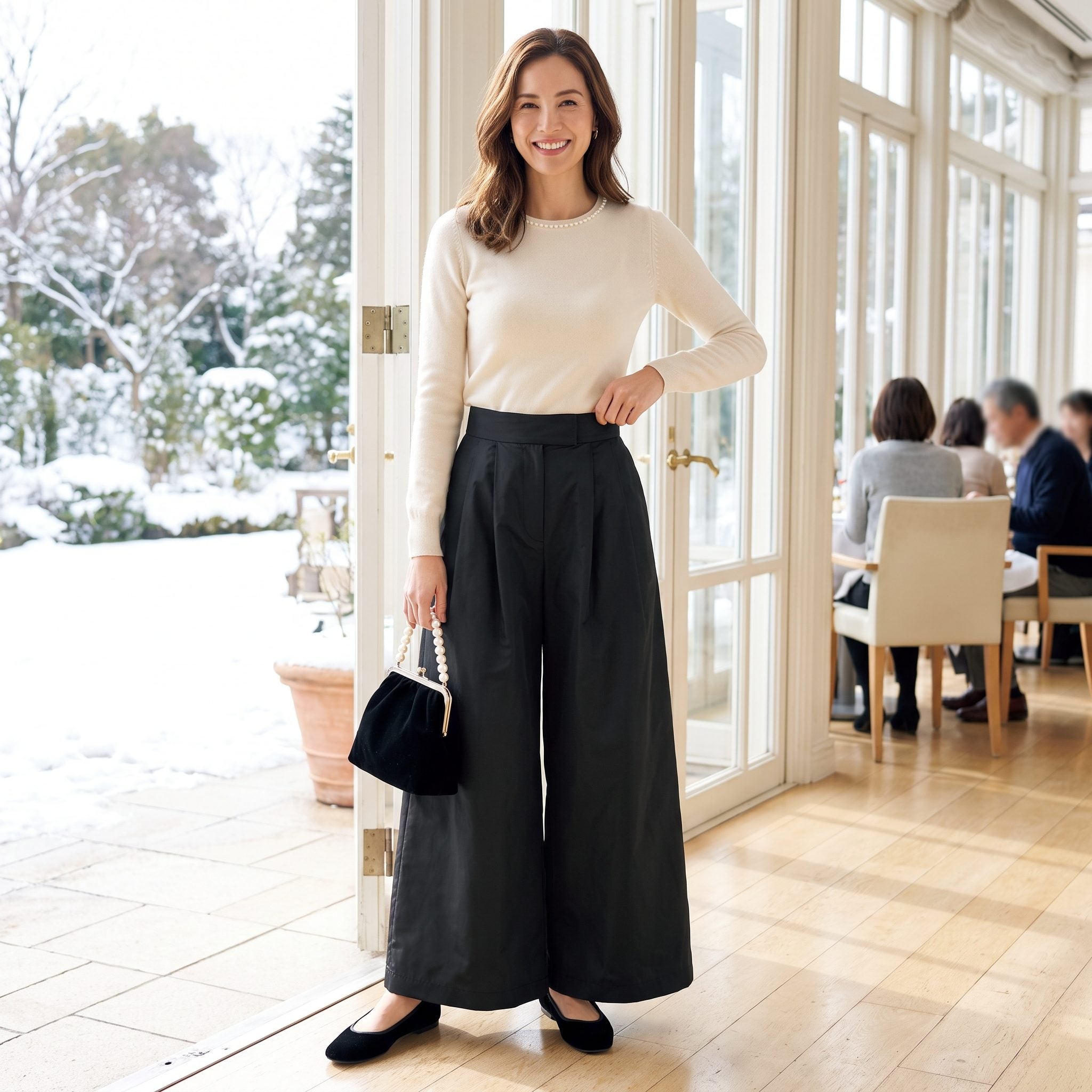 Cream pearl-trim sweater with black taffeta trousers, velvet flats, and pearl-handled handbag