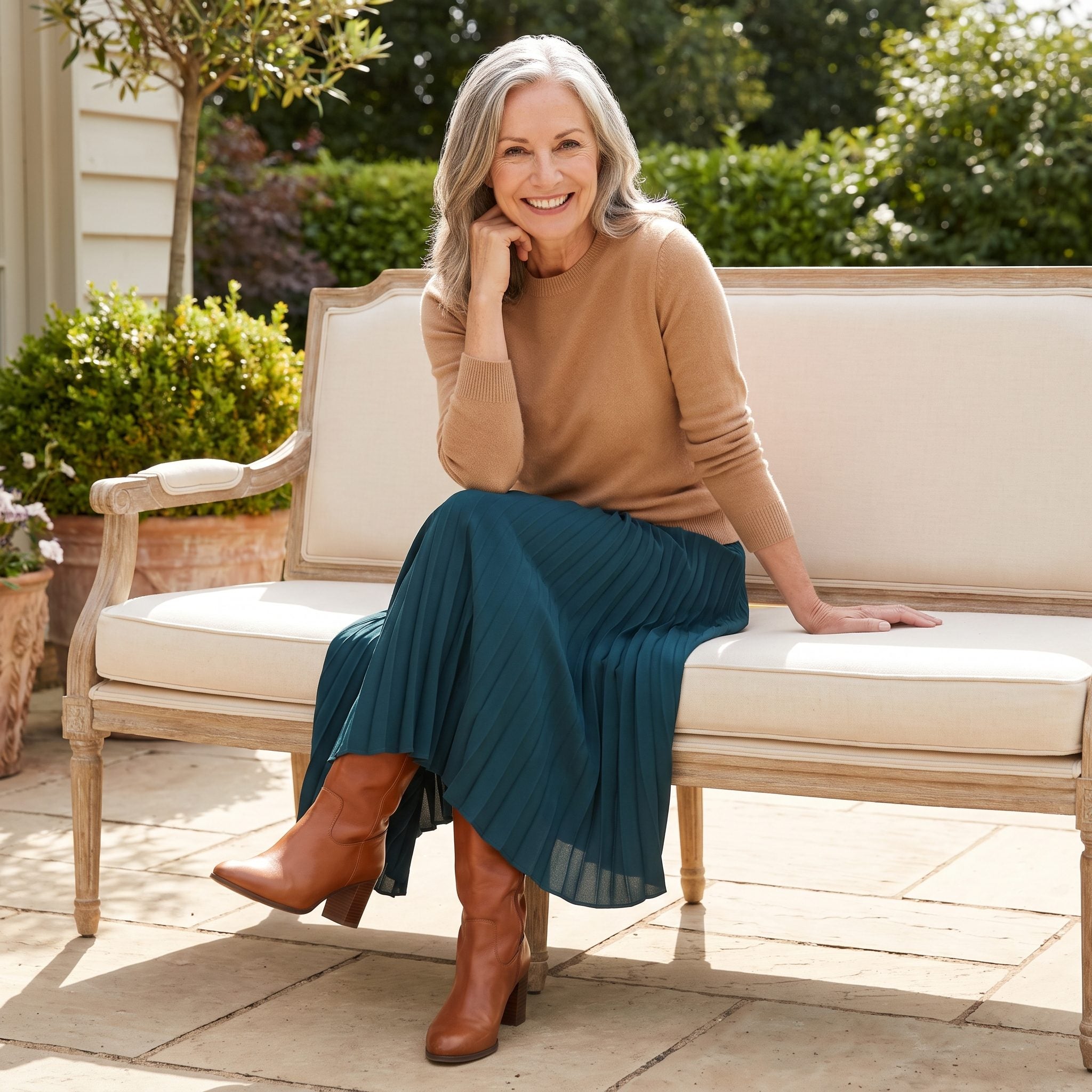 Deep-teal pleated midi skirt with camel cashmere and cognac boots