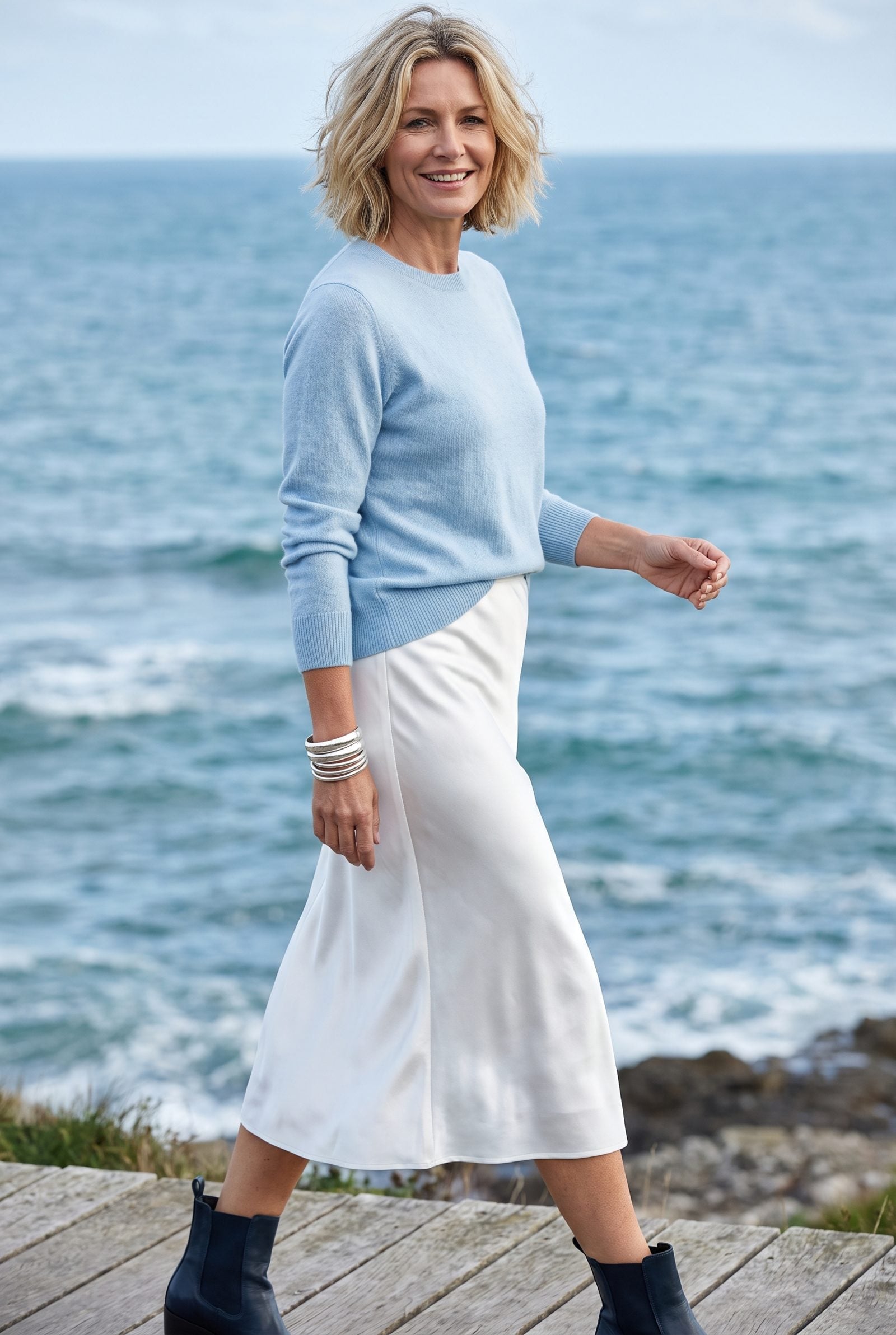 Ice-Blue Sweater and White Satin Skirt With Silver Bangles