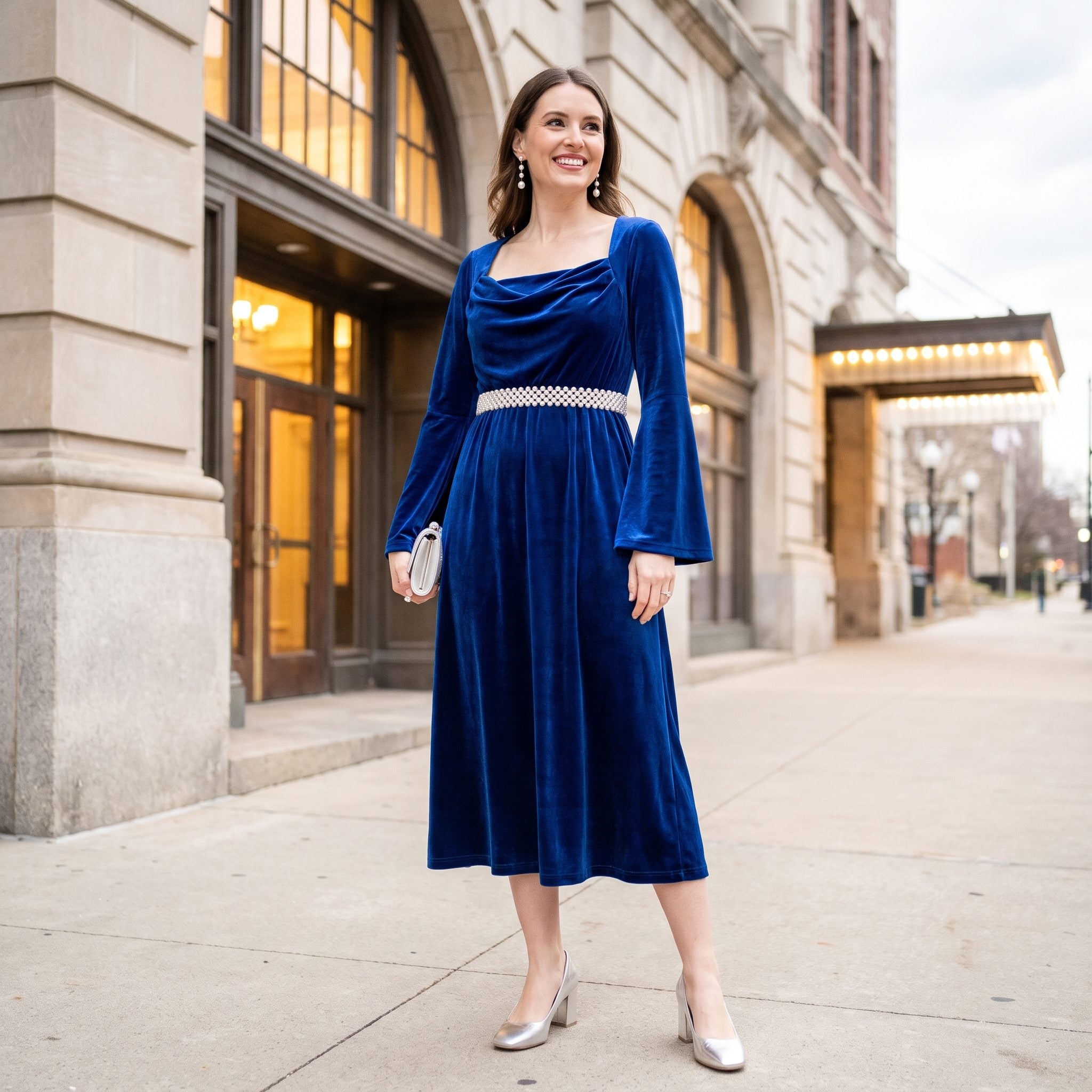 Sapphire velvet evening dress with a pearl belt positioned beneath the bust