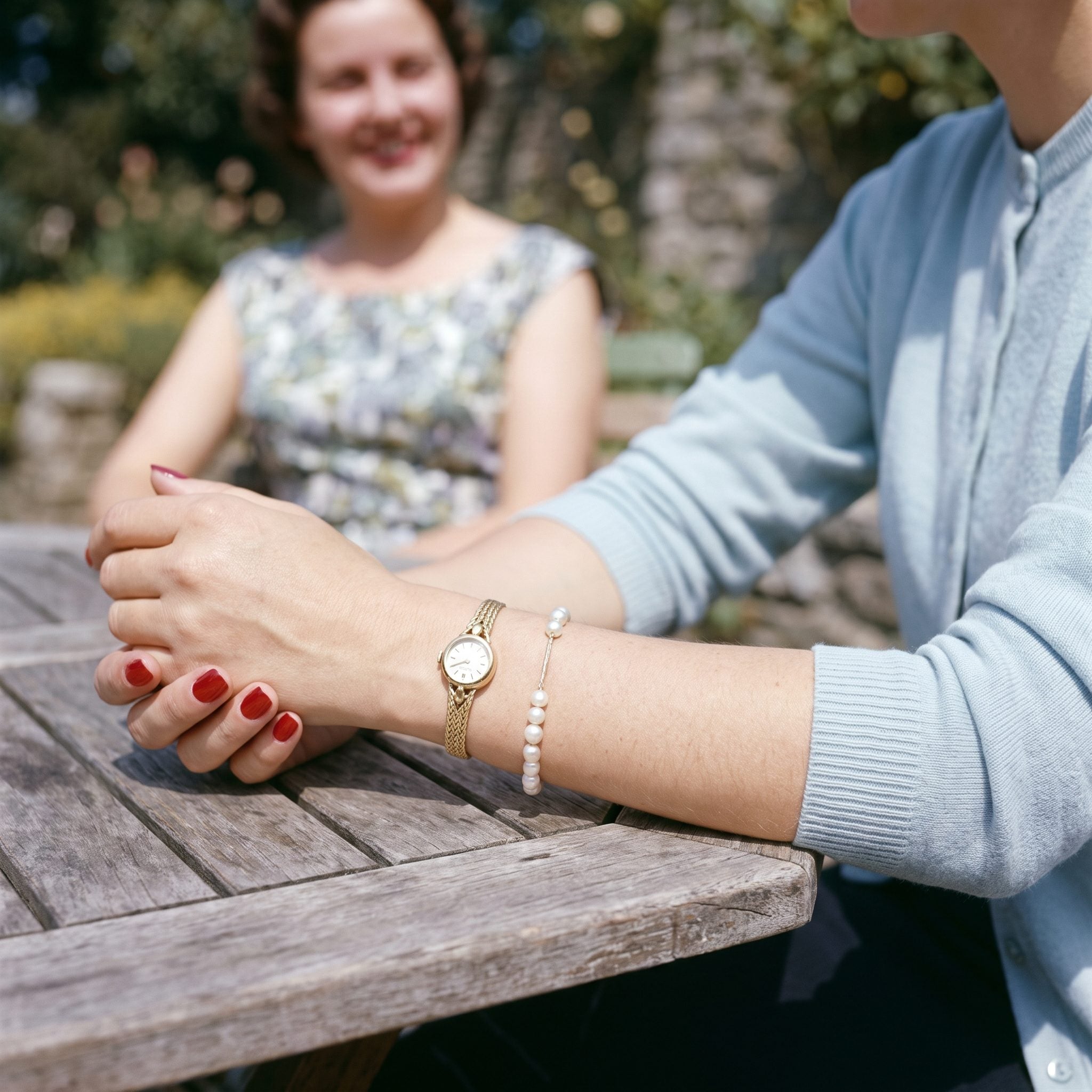 Petite 1950s women's wristwatch with a slender gold-colored bracelet