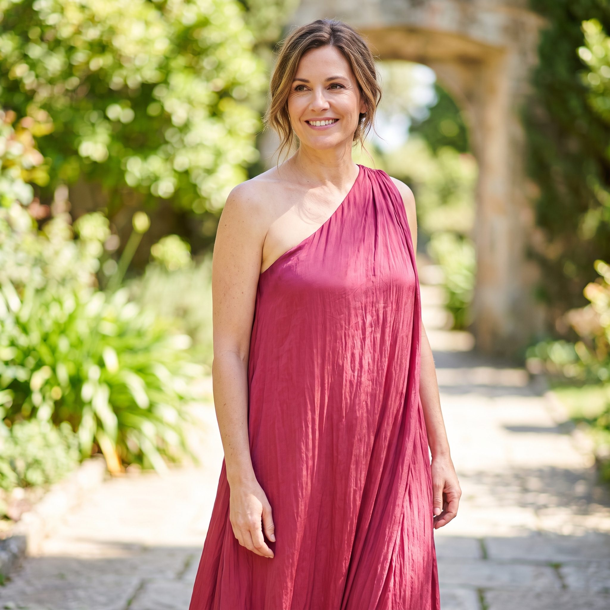 Raspberry-colored one-shoulder evening dress with gathered draping