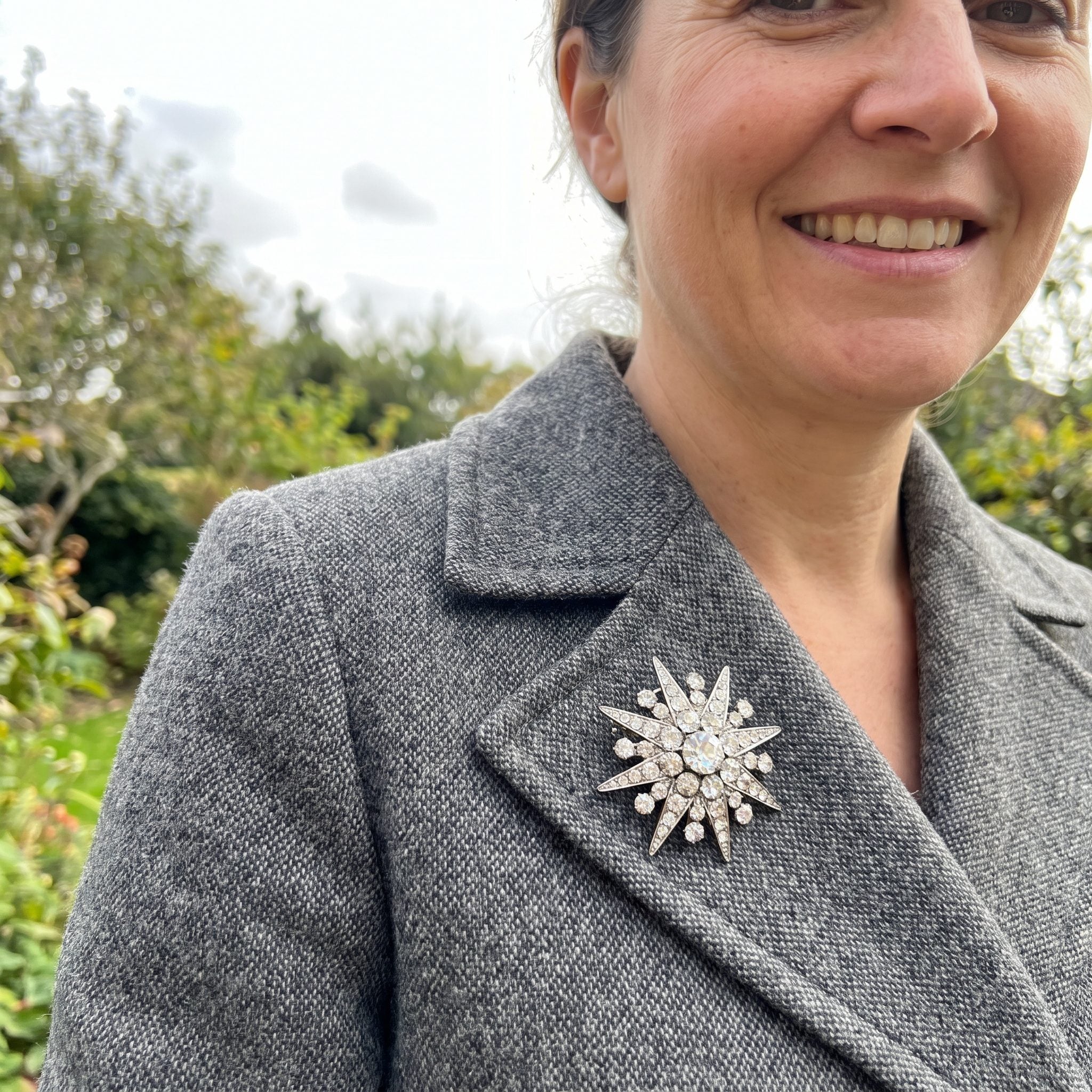 Sparkling 1950s rhinestone brooch pinned to a coat lapel