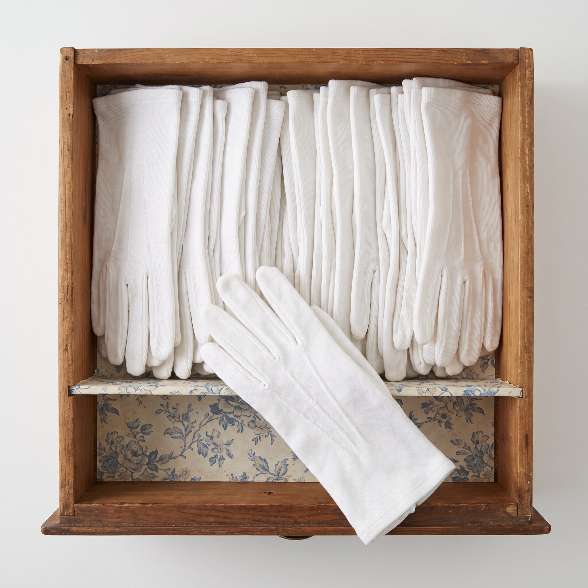 White cotton dress gloves worn with 1950s women's fashion